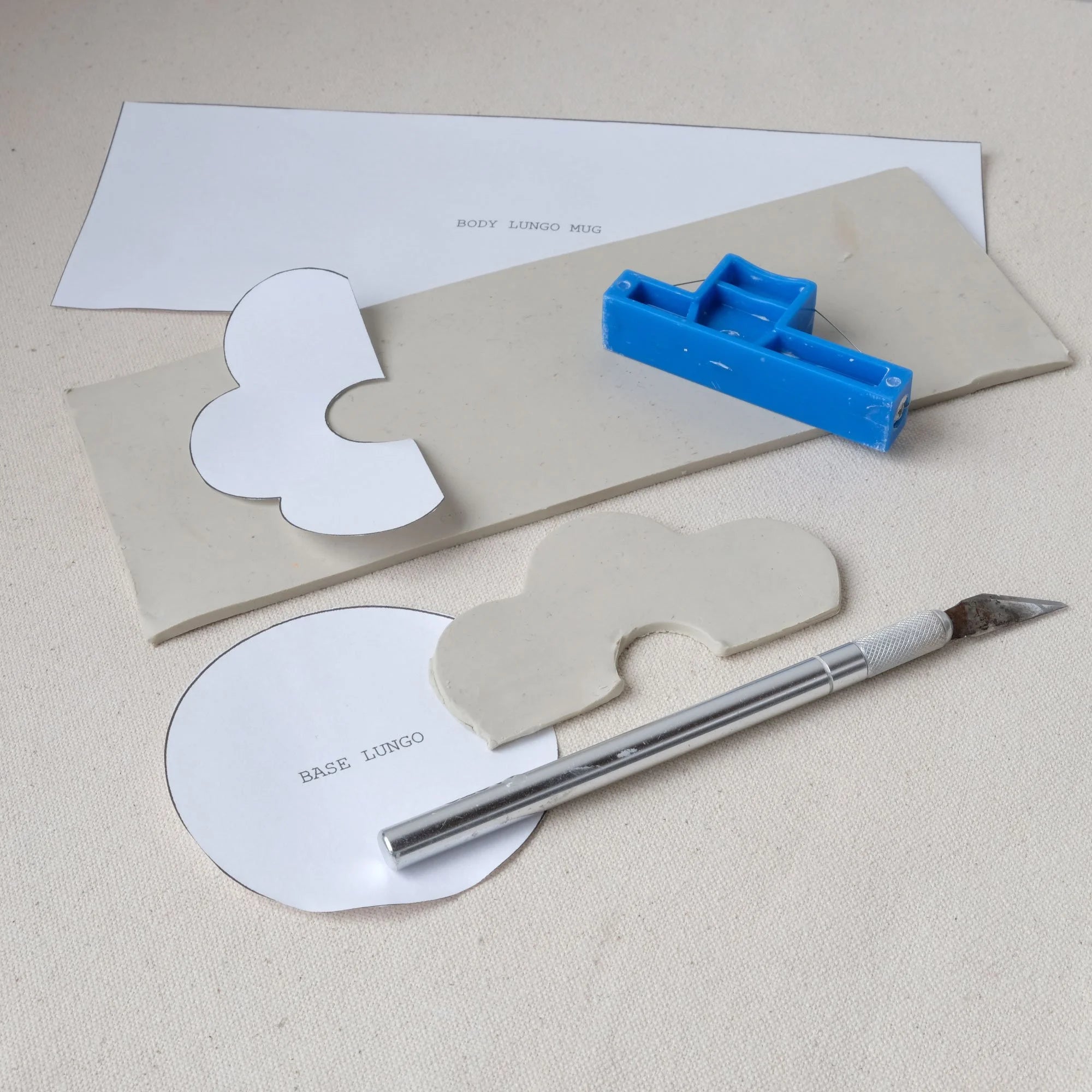 Pottery template system and cutters on a canvas surface