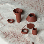 Clay pots and bowls templates on a textured surface with abstract designs.