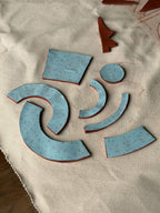 Ceramic slab template pieces on a textured canvas